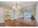 Spacious dining area showcasing hardwood floors, a chandelier, and a dry bar at 1115 Shadow Lake Cir, Mount Pleasant, SC 29464
