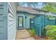 Cozy entryway showcasing a well-lit entrance with a storm door and green fence at 1115 Shadow Lake Cir, Mount Pleasant, SC 29464