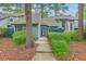 Charming townhome featuring mature landscaping leading to a welcoming front entrance at 1115 Shadow Lake Cir, Mount Pleasant, SC 29464