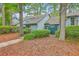 Exterior view of a charming townhome with mature landscaping and a walkway at 1115 Shadow Lake Cir, Mount Pleasant, SC 29464