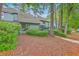 Exterior view of a townhome featuring lush greenery and a well-maintained lawn at 1115 Shadow Lake Cir, Mount Pleasant, SC 29464