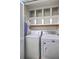 Functional laundry room with washer, dryer, and built-in shelving for storage at 1115 Shadow Lake Cir, Mount Pleasant, SC 29464