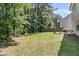 Large, grassy backyard area with mature trees, providing ample space for recreation and outdoor activities at 113 Southernwood Dr, Ladson, SC 29456