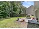 Lush backyard area with a grill and concrete patio, ideal for outdoor entertaining and summer barbecues at 113 Southernwood Dr, Ladson, SC 29456