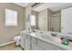 Bathroom has a double-sink vanity with white cabinets and a shower with sliding doors at 113 Southernwood Dr, Ladson, SC 29456
