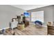Bedroom with wood floors includes a flat screen TV, furnishings and a window for natural light at 113 Southernwood Dr, Ladson, SC 29456