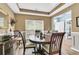 Well-lit dining area featuring a round table and chairs, complemented by a buffet and natural light through window blinds at 113 Southernwood Dr, Ladson, SC 29456