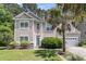 Charming two-story home featuring a well-manicured lawn, two-car garage, and mature landscaping at 113 Southernwood Dr, Ladson, SC 29456