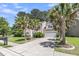 Inviting home exterior with lush palm trees, a spacious driveway, and a well-maintained lawn at 113 Southernwood Dr, Ladson, SC 29456
