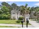 Beautiful home exterior featuring palm trees, a well-manicured lawn, and a welcoming two-car garage at 113 Southernwood Dr, Ladson, SC 29456