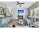 Comfortable living room with a fireplace, ceiling fan, and natural light from the many bright windows at 113 Southernwood Dr, Ladson, SC 29456