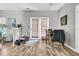 Bright living room with patio doors, adjacent dining table and open space, presenting versatile living and entertaining options at 113 Southernwood Dr, Ladson, SC 29456