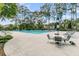 Community pool area with lounge chairs, tables, and lush greenery providing a relaxing outdoor space at 113 Southernwood Dr, Ladson, SC 29456
