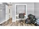 An underutilized room with wood-look floors contains a desk and piles of garbage at 113 Southernwood Dr, Ladson, SC 29456