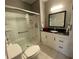 Bathroom featuring granite vanity, toilet and tiled walk-in shower at 116 W 5Th South St # D, Summerville, SC 29483
