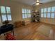 Bedroom with hardwood flooring, ceiling fan, and three large windows at 116 W 5Th South St # D, Summerville, SC 29483