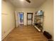 Bedroom with hardwood flooring, ceiling fan, and view into walk-in laundry area at 116 W 5Th South St # D, Summerville, SC 29483