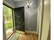 Inviting entryway with a stylish chandelier, wooden floors, and a view of the outdoors through the open door at 116 W 5Th South St # D, Summerville, SC 29483