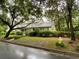 Exterior view of a beautiful home surrounded by lush greenery and mature trees, showcasing its curb appeal at 116 W 5Th South St # D, Summerville, SC 29483