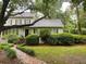 Charming home with a lush front yard, green bushes, and a brick pathway leading to the front door at 116 W 5Th South St # D, Summerville, SC 29483