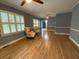 Spacious living room with hardwood floors, neutral paint, and large windows providing natural light at 116 W 5Th South St # D, Summerville, SC 29483