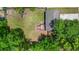 Aerial view shows backyard with privacy fence, wooden deck with chairs, and lush green trees at 117 Canaberry Cir, Summerville, SC 29483
