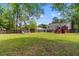 Well-maintained backyard with a playset, wooden fence, and spacious grassy area at 117 Canaberry Cir, Summerville, SC 29483