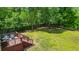 Large backyard featuring lush green grass, mature trees, a wood fence and a deck at 117 Canaberry Cir, Summerville, SC 29483