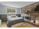 Bedroom with brick fireplace, window view, and comfortable furnishings at 117 Canaberry Cir, Summerville, SC 29483