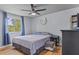 Bright bedroom featuring a queen bed, hardwood floors, and a ceiling fan at 117 Canaberry Cir, Summerville, SC 29483