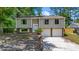 Charming two-story home with a brick and siding exterior, mature trees and attached two-car garage at 117 Canaberry Cir, Summerville, SC 29483