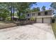 Two-story home with a spacious driveway, a brick accent wall and mature trees at 117 Canaberry Cir, Summerville, SC 29483