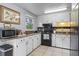 Well-lit kitchen featuring black appliances, white cabinets, and granite countertops at 117 Canaberry Cir, Summerville, SC 29483
