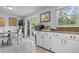 Bright kitchen with white cabinets, granite countertops, and access to the deck at 117 Canaberry Cir, Summerville, SC 29483