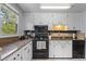 Bright kitchen featuring black appliances, white cabinets, and granite countertops at 117 Canaberry Cir, Summerville, SC 29483