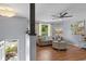 Cozy living room with a brown couch, wooden floors, and a ceiling fan at 117 Canaberry Cir, Summerville, SC 29483