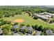 Expansive aerial view of a neighborhood featuring green lawns, tennis court, and mature tree coverage at 1225 Blakeway St # 407, Charleston, SC 29492