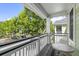 Balcony area with a table and seating, overlooking street with trees at 1225 Blakeway St # 407, Charleston, SC 29492
