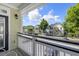 View from balcony overlooking street with tropical trees and building exteriors at 1225 Blakeway St # 407, Charleston, SC 29492
