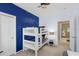 A bedroom decorated with patriotic themes and a bunk bed leading to an ensuite bathroom at 1225 Blakeway St # 407, Charleston, SC 29492