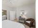 Bright bedroom featuring a ceiling fan, woven chair, and a stylish decorative mirror on the dresser at 1225 Blakeway St # 407, Charleston, SC 29492