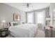 Bright bedroom with a large bed, ceiling fan, and two windows providing natural light at 1225 Blakeway St # 407, Charleston, SC 29492