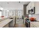 Stylish kitchen with stainless appliances, modern countertops, and an open view to the dining area at 1225 Blakeway St # 407, Charleston, SC 29492