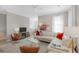 Cozy living room featuring a white leather couch, modern furnishings, and ample natural light at 1225 Blakeway St # 407, Charleston, SC 29492