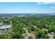 Aerial view of a neighborhood full of green trees and blue water with a bridge in the distance under a bright sky at 1416 Glencoe Dr, Mount Pleasant, SC 29464