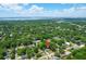 This aerial view showcases a neighborhood that is full of lush trees with bright blue skies overhead and a bridge in distance at 1416 Glencoe Dr, Mount Pleasant, SC 29464
