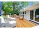 Back deck area featuring gray cushioned chairs, foot rests, wooden bench, and access to backyard at 1416 Glencoe Dr, Mount Pleasant, SC 29464