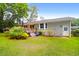 Spacious backyard featuring lush lawn, landscaping, exterior of home, and a blue umbrella at 1416 Glencoe Dr, Mount Pleasant, SC 29464
