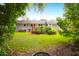 The expansive backyard shows the home's exterior, lush lawn and a mature tree line at 1416 Glencoe Dr, Mount Pleasant, SC 29464