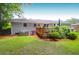 Well-maintained backyard showing the home's exterior, landscaping, and a small deck at 1416 Glencoe Dr, Mount Pleasant, SC 29464